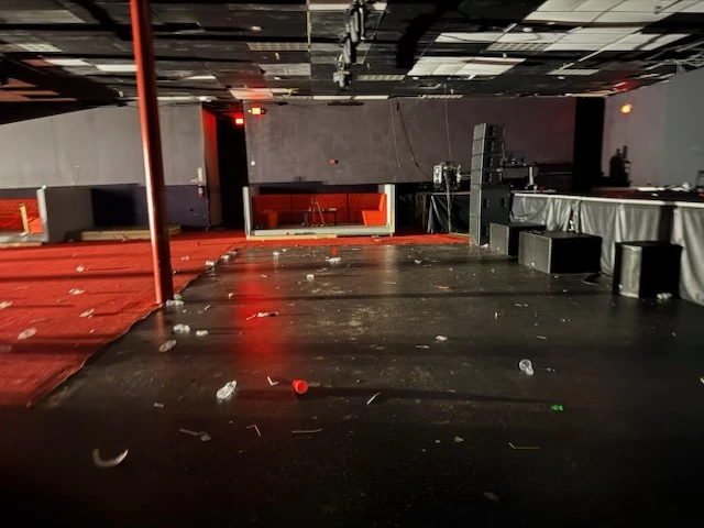 Post-event debris on the open floor in front of the stage