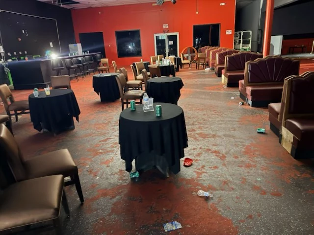 Tables and lounge seating with bottles and post-event litter