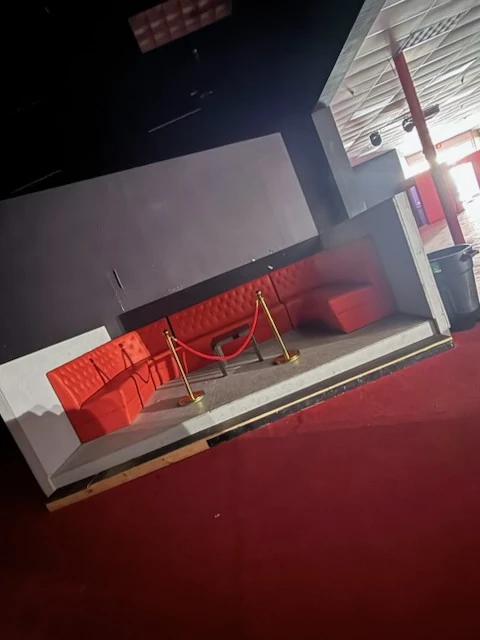 Cleared red booth seating and surrounding floor