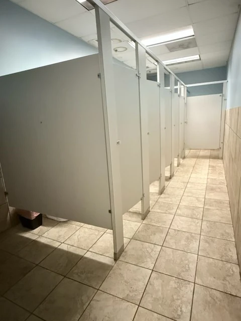 Restroom cubicles and cleared tiled walkway